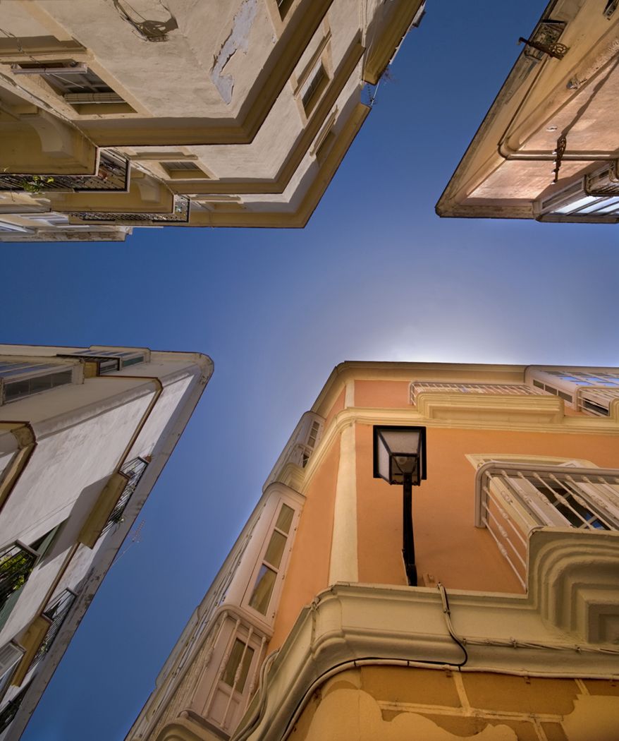 Ultrai wide angle 10mm on the ground looking up at a junction in old town part of Cadiz