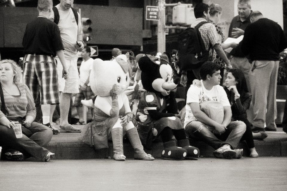 While sitting on Times Square, I noticed two people in costumes, giving away some leaflets. After a while, they both sat on the kerb, dissapointed. The photo expresses this moment.